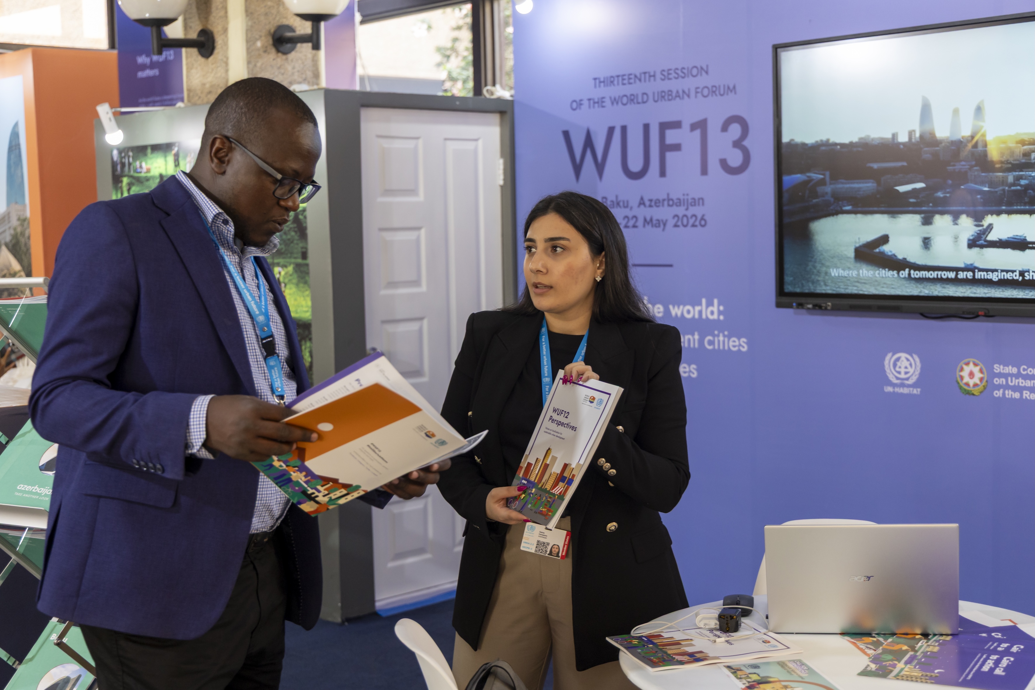 A delegate learned about the impact of WUF at the WUF13 booth during the Assembly. © UN-Habitat/Peter Ndolo