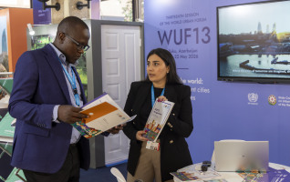 A delegate learned about the impact of WUF at the WUF13 booth during the Assembly. © UN-Habitat/Peter Ndolo