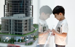 A child inspects an architectural model at WUF13 in Baku, Azerbaijan. © UN-Habitat/Ratmir