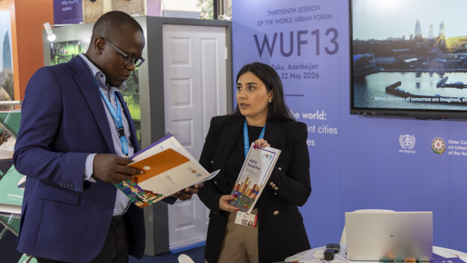 A delegate learned about the impact of WUF at the WUF13 booth during the Assembly. © UN-Habitat/Peter Ndolo